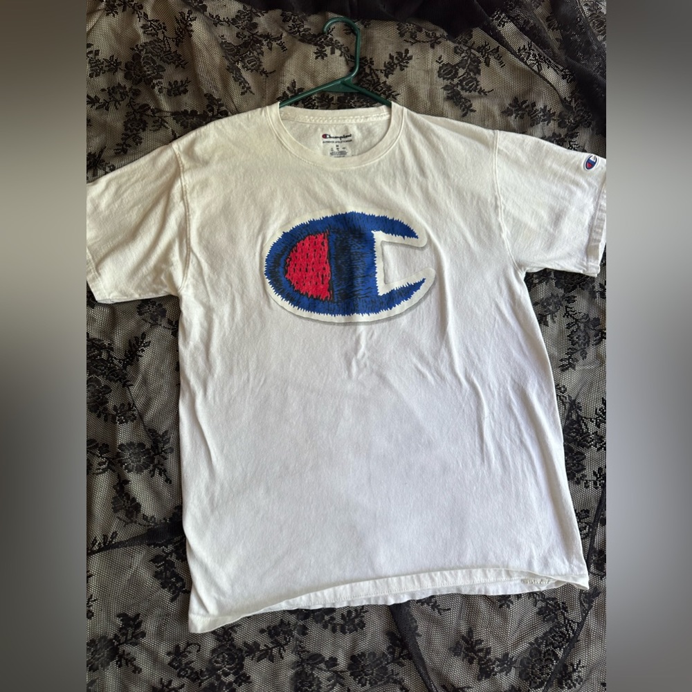 Champion white medium shirt. Small mark on front of shirt.